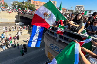 Protesters rally at Alameda and highway 101 to protest against President Trump's deportation policies.