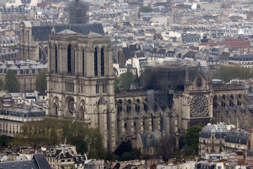 Notre Dame cathedral is pictured from the top of the Montparnasse tower, Tuesday April 16, 2019 in Paris. Firefighters declared success Tuesday morning in an over 12-hour battle to extinguish an inferno engulfing Paris' iconic Notre Dame cathedral that claimed its spire and roof, but spared its bell towers. (AP Photo/Thibault Camus)