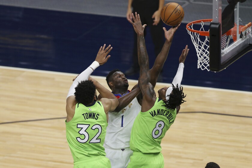 New Orleans Pelicans' Zion Williamson (1) shoots against Minnesota Timberwolves' Karl-Anthony Towns (32) and Jarred Vanderbilt (8) during the first half of an NBA basketball game Saturday, May 1, 2021, in Minneapolis. (AP Photo/Stacy Bengs)