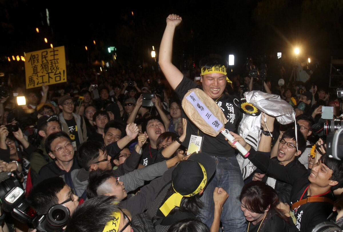 Protesters against a Taiwanese trade pact with China cheer after leaving the legislature in Taipei.