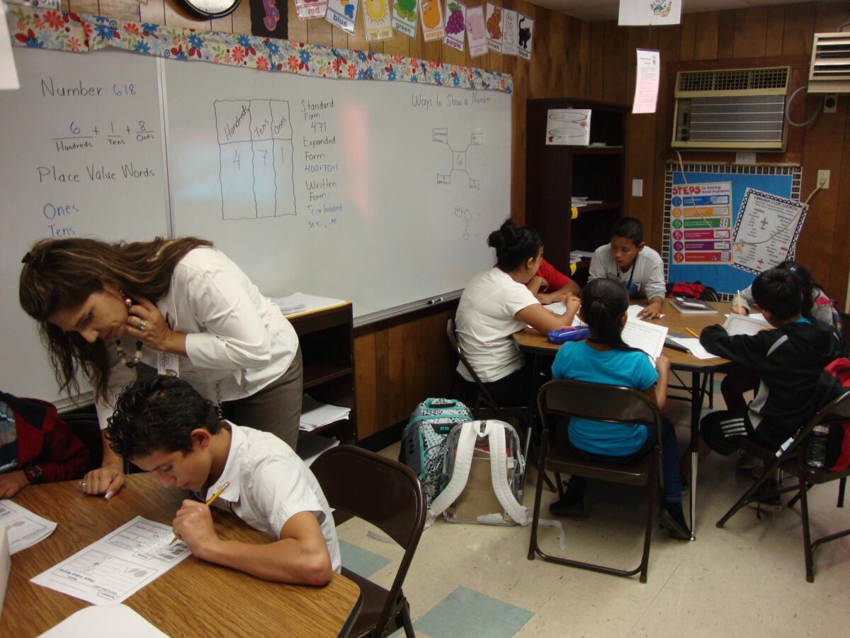 Principal Marie Moreno works with Central American immigrant students at Las Americas Newcomer School in Houston last year.