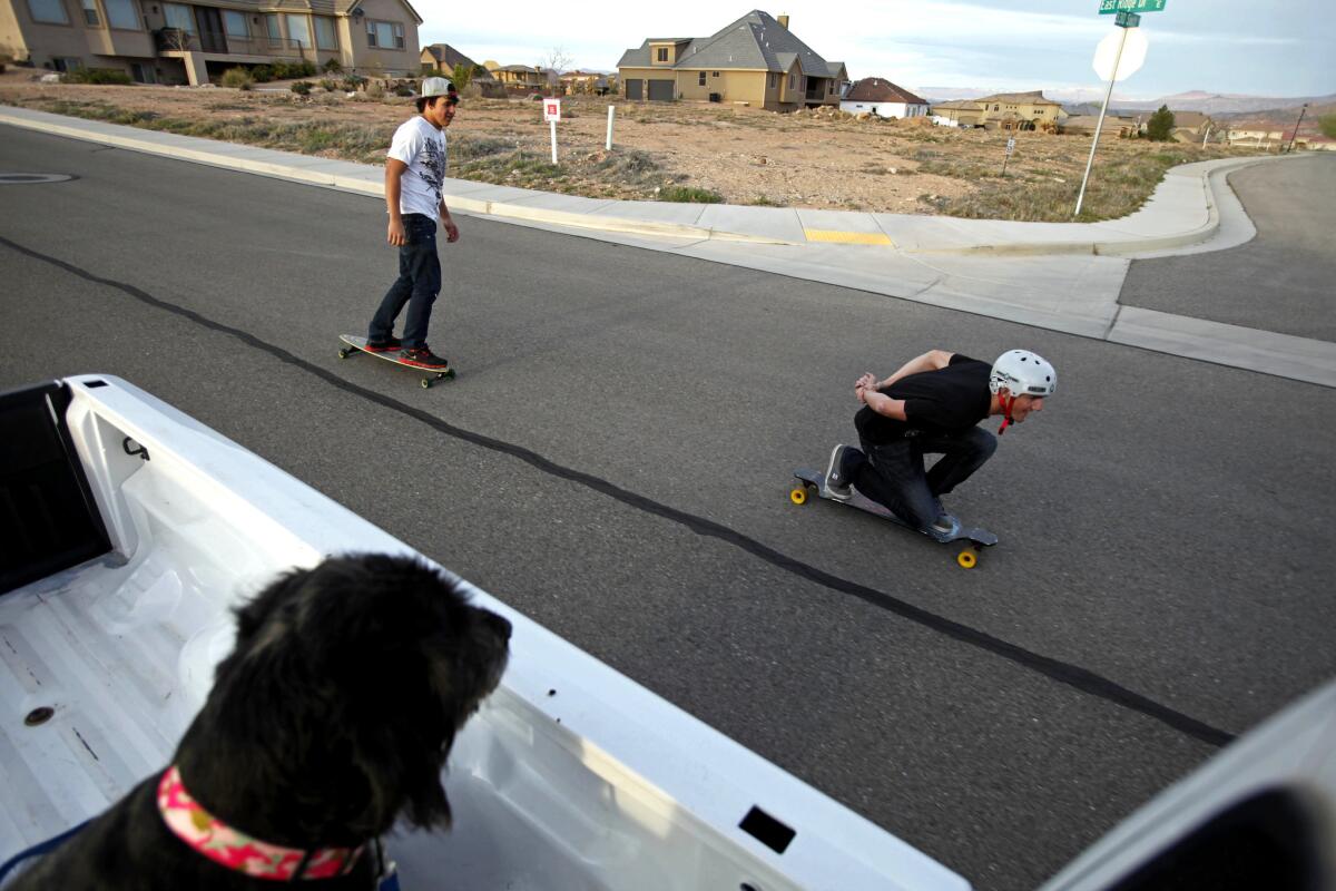 Isaiah and Zach Bowers, 18, from left, head for a hill on their skateboards in their St. George neighborhood. They are gradually adapting to their new lives with a mainstream Mormon foster family.