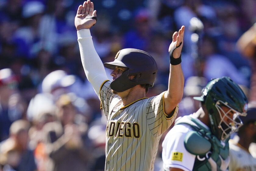 San Diego Padres' Wil Myers celebrates his home run in the third inning of a baseball game against the Colorado Rockies Sunday, Sept. 25, 2022, in Denver. (AP Photo/Geneva Heffernan)