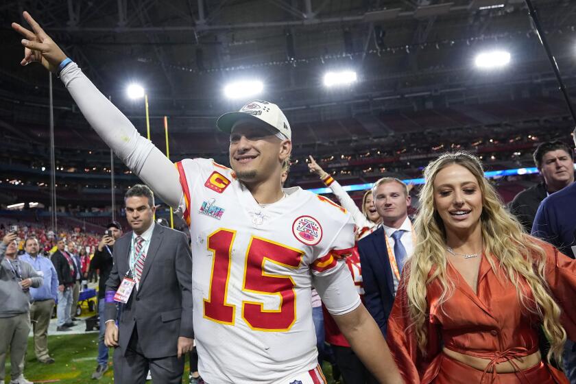 Kansas City Chiefs quarterback Patrick Mahomes (15) leaves the field with his wife Brittany