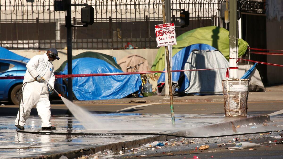 City crews on skid row cleaned East 5th Street Monday near where L.A. Catholic worker Kaleb Havens has been on a hunger strike to demand action by leaders to address the homeless crisis in LA.