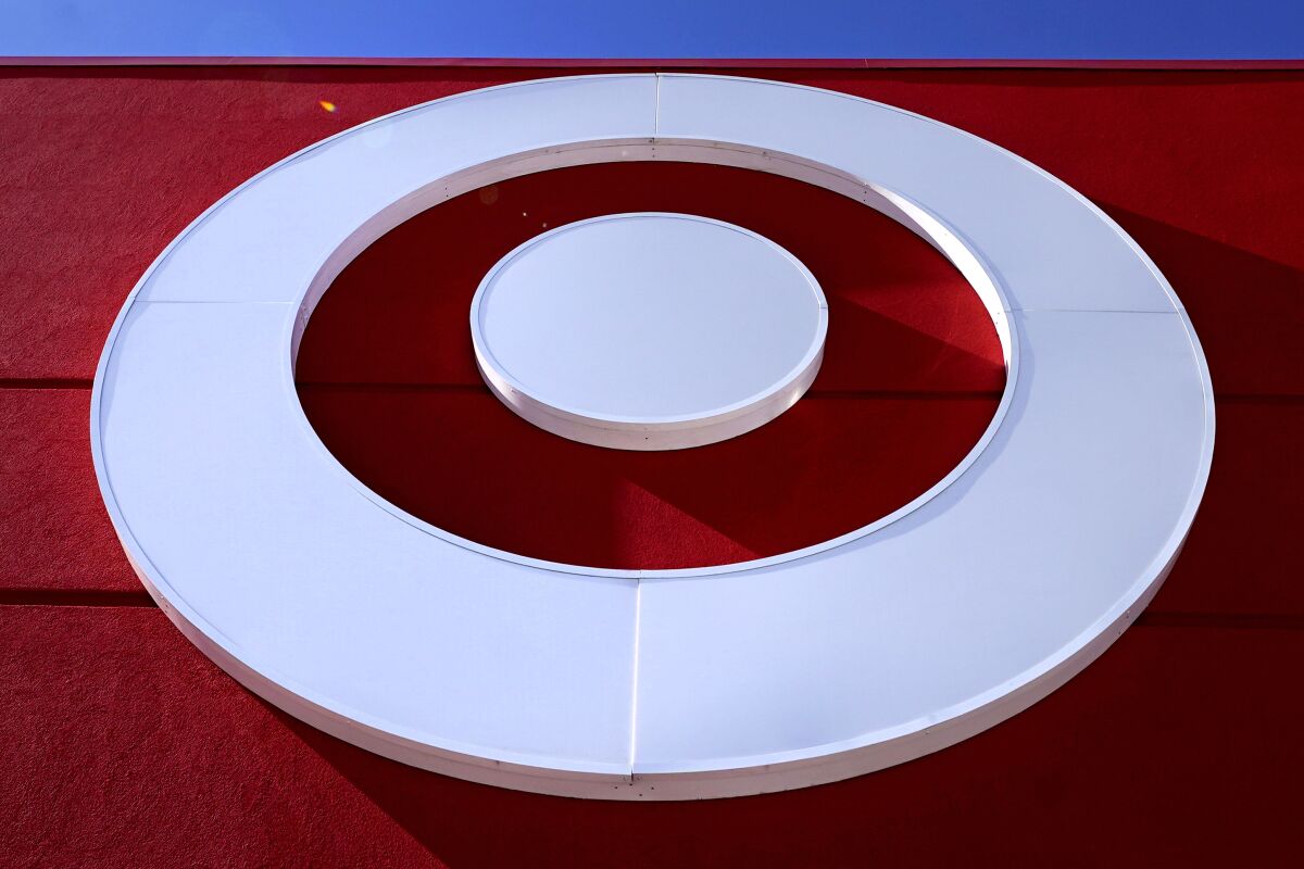 The bullseye logo on the Target store in the South Bay neighborhood of Boston, Monday, Feb. 28, 2022. Target pushed through headwinds — from inflation to congested ports — to deliver solid results for the three-month period that included the crucial holiday shopping season. The Minneapolis-based discount retailer reported Tuesday that its fiscal fourth-quarter profits rose nearly 12%, while sales increased 9.4%. (AP Photo/Charles Krupa)