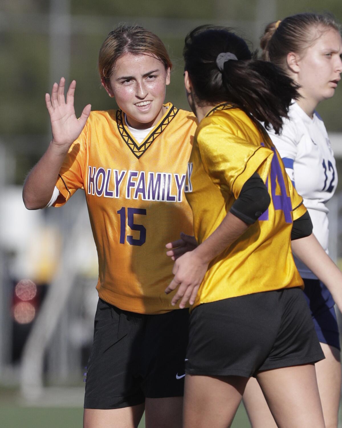 Holy Family's Brianna Cindrich is congratulated by teammate Maya Devora after scoring in a Horizon League girls' soccer game at the Glendale Sports Complex in Glendale on Monday, January 27, 2020.