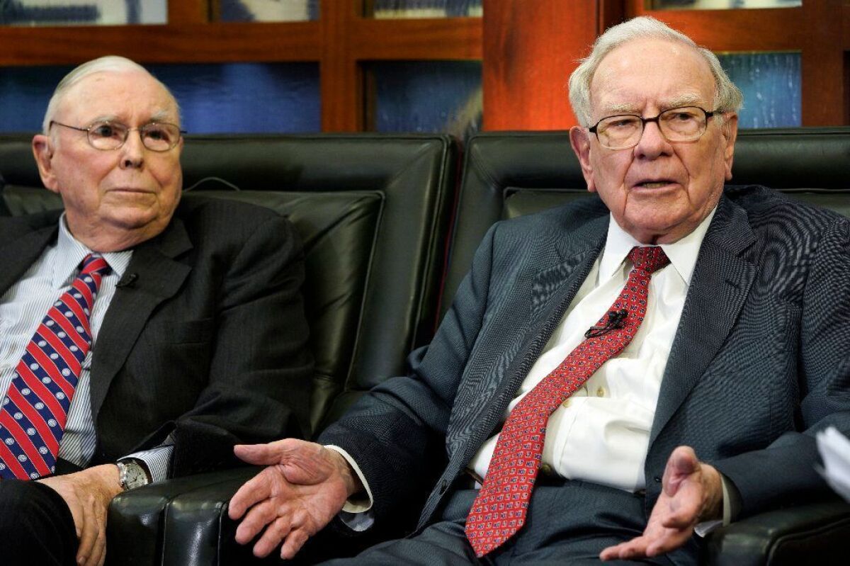 Berkshire Hathaway Vice Chairman Charlie Munger, left, and Chairman and Chief Executive Warren Buffett speak during an interview in Omaha on May 7.