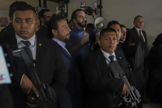 Members of the presidential security command surround El Salvador's President Nayib Bukele, center, during their speech to supporters in San Salvador, El Salvador, Friday, Oct. 27, 2023. (AP Photo/Salvador Melendez)
