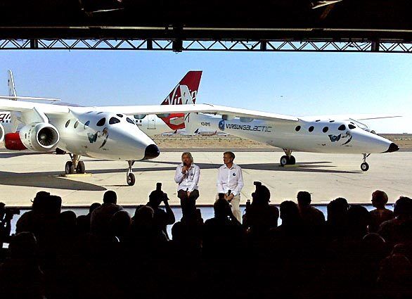 Richard Branson, left, and Burt Rutan unveil a plane that they say will serve as the mothership for the world's first commercial spaceflight.