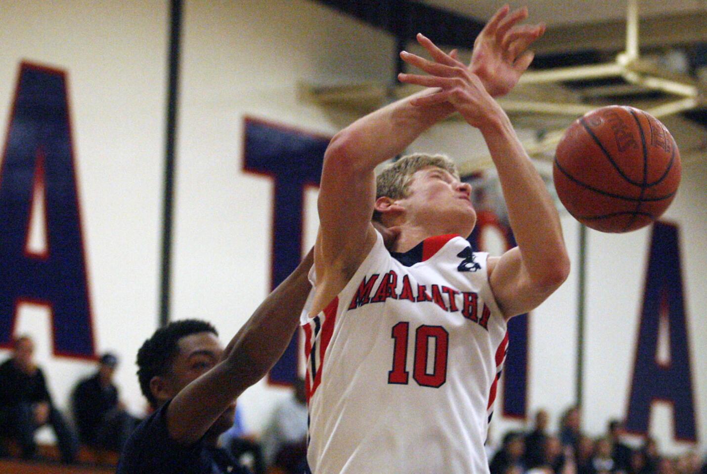 La Salle's Jalen Gray, left, fouls Maranatha's Michael DeMeester during a game at Maranatha High School in Pasadena on Friday, January 4, 2013.