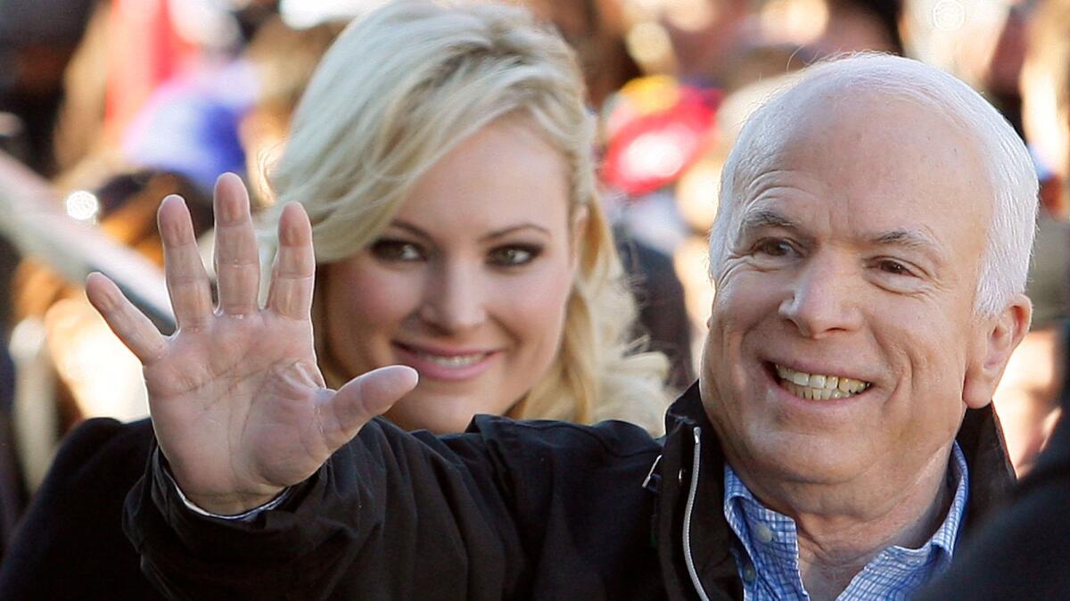 Then-Republican presidential candidate Sen. John McCain, accompanied by his daughter Meghan McCain, waves to supporters in Ohio in October 2008.
