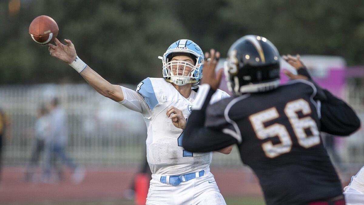 Corona del Mar High quarterback Ethan Garbers, seen throwing under pressure at JSerra on Aug. 17, has passed for 1,078 yards and 13 touchdowns, with one interception in four games this season.