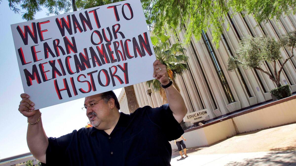 Carlos Galindo protests outside the Arizona Department of Education in Phoenix in 2011.