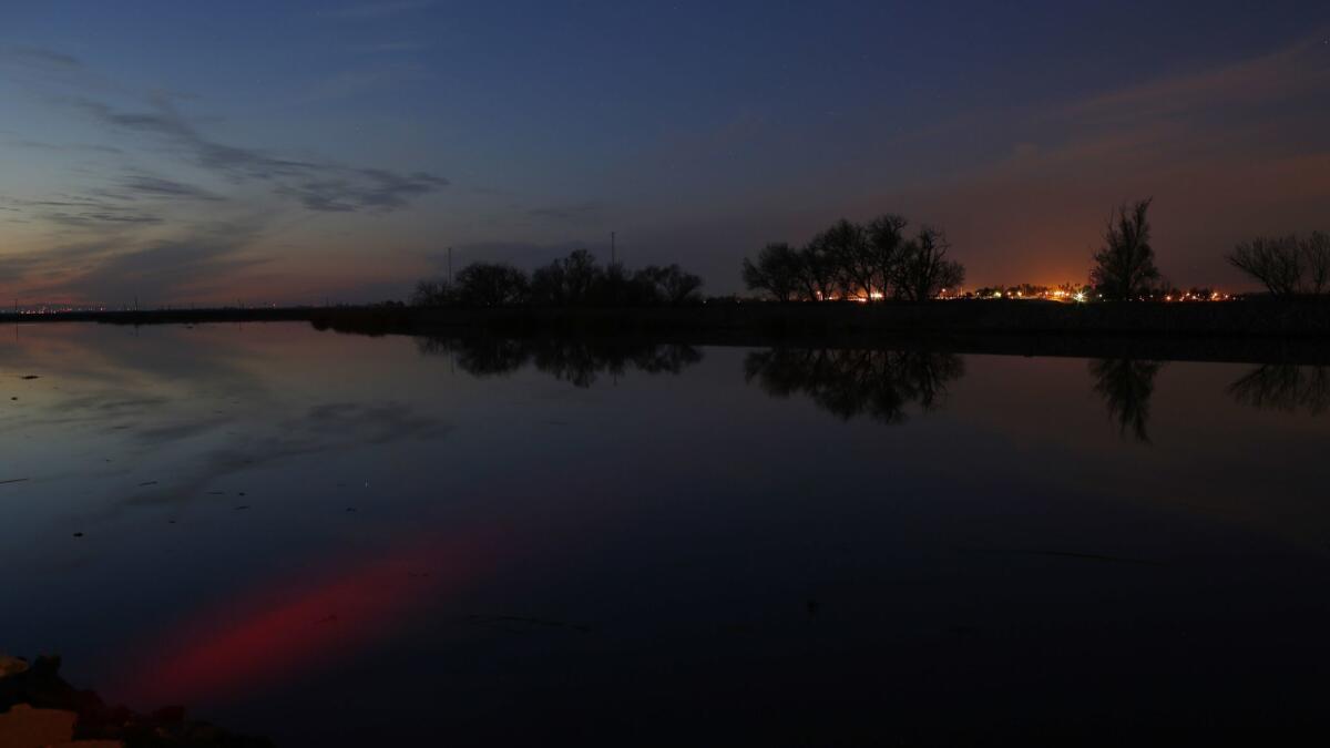 The sunset is reflected in the Middle River in the Sacramento-San Joaquin Delta.