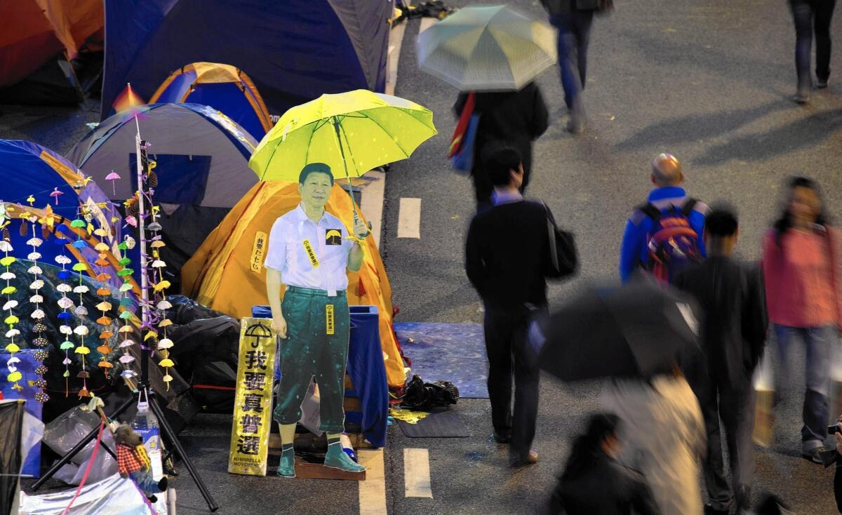 A cardboard cutout of Chinese President Xi Jinping carrying a yellow umbrella at the Hong Kong pro-democracy movement's main protest site in the Admiralty district on Dec. 2.