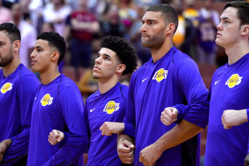 ANAHEIM, CA - SEPTEMBER 30: (left to right) Andrew Bogut, Kyle Kuzma, Lonzo Ball, Brook Lopez and Stephen Zimmerman of Los Angeles Lakers lock arms during the national anthem before the start of the game against the Minnesota Timberwolves on September 30, 2017 at the Honda Center in Anaheim, California. NOTE TO USER: User expressly acknowledges and agrees that, by downloading and or using this photograph, User is consenting to the terms and conditions of the Getty Images License Agreement. (Photo by Robert Laberge/Getty Images) ** OUTS - ELSENT, FPG, CM - OUTS * NM, PH, VA if sourced by CT, LA or MoD **