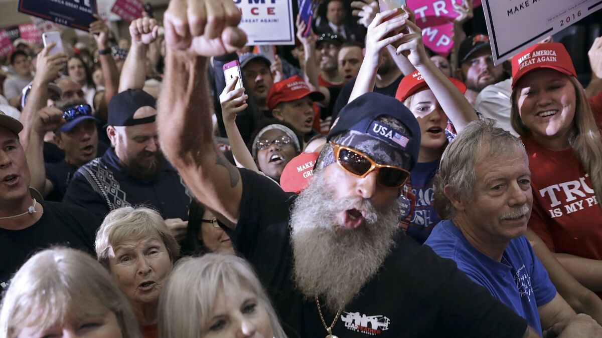 Supporters cheer for their candidate at a Donald Trump rally in Tampa, Fla. Trump was able to flip several states that had voted twice for President Obama, including Florida.