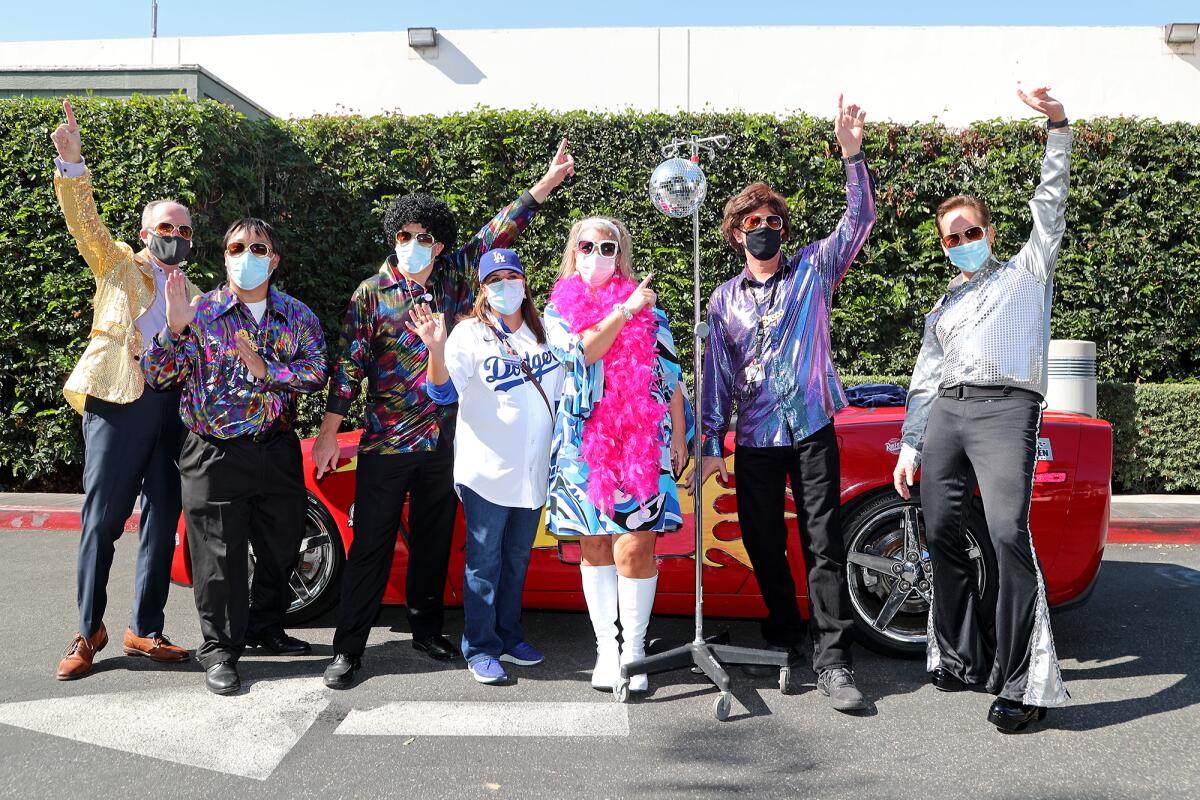 Faculty and staff members pose for a group photo after the 14th annual Pediatric Trick-Or-Treat Parade.