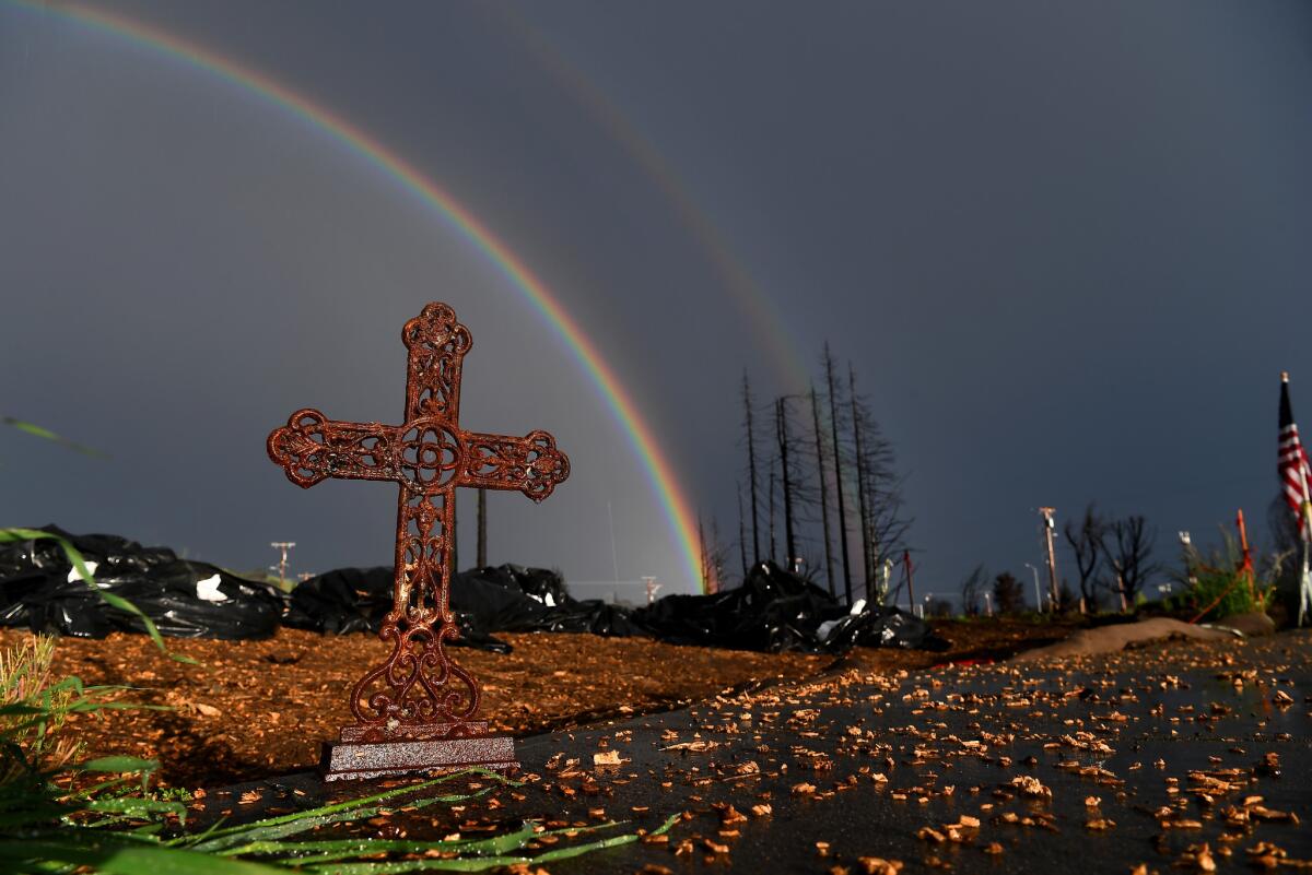 A rainbow rises above the empty lots at Mark West Estates in Santa Rosa.