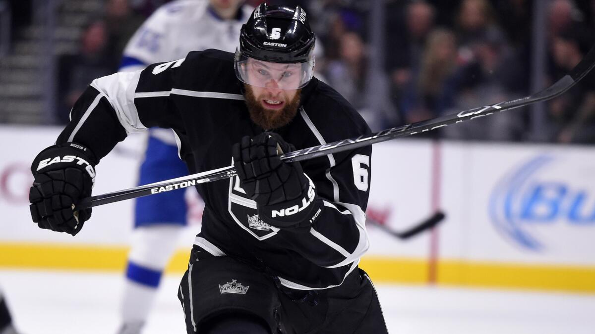 Kings defenseman Jake Muzzin rushes toward the puck during a game against the Lightning.