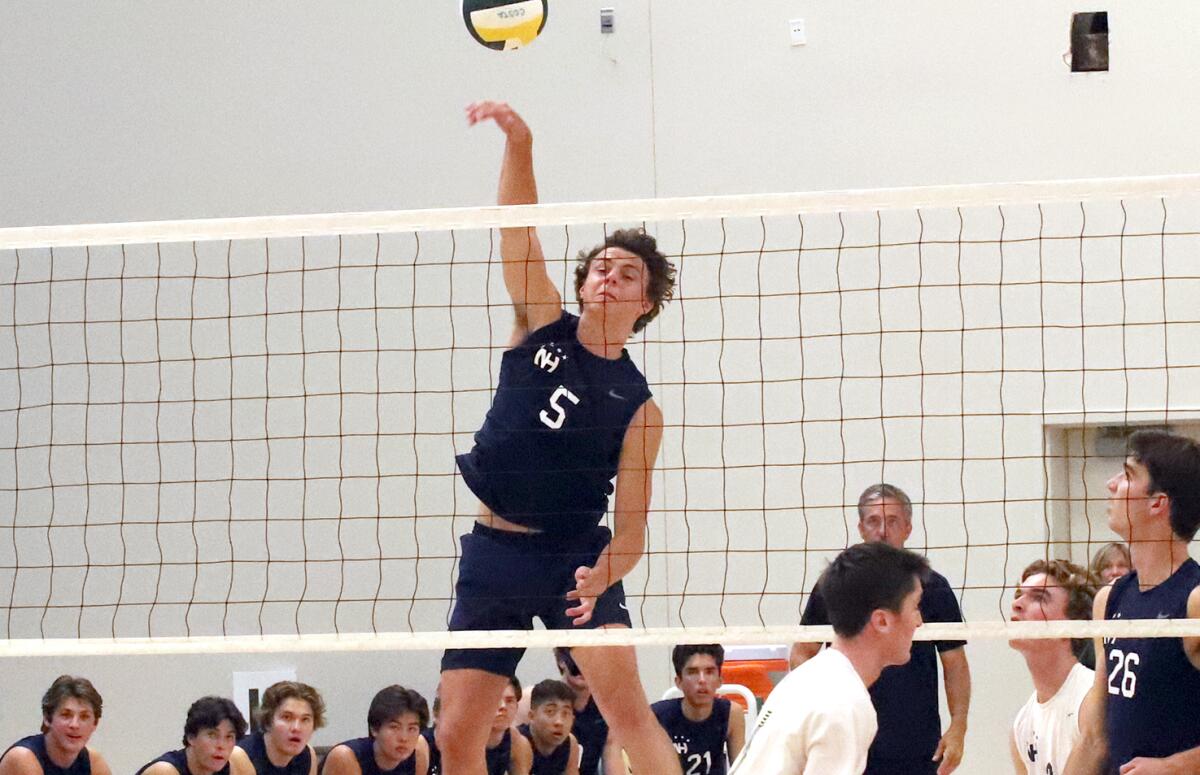 Newport Harbor's Riggs Guy (5) spikes for a point against Mira Costa on Saturday.