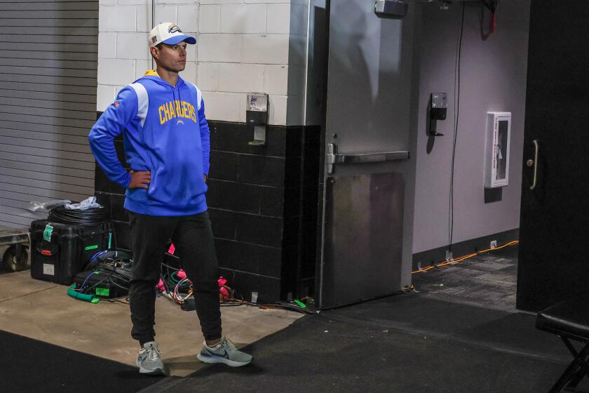 Coach Brandon Staley stands outside the locker room after his Chargers blew a 27-point playoff game lead to the Jaguars. 