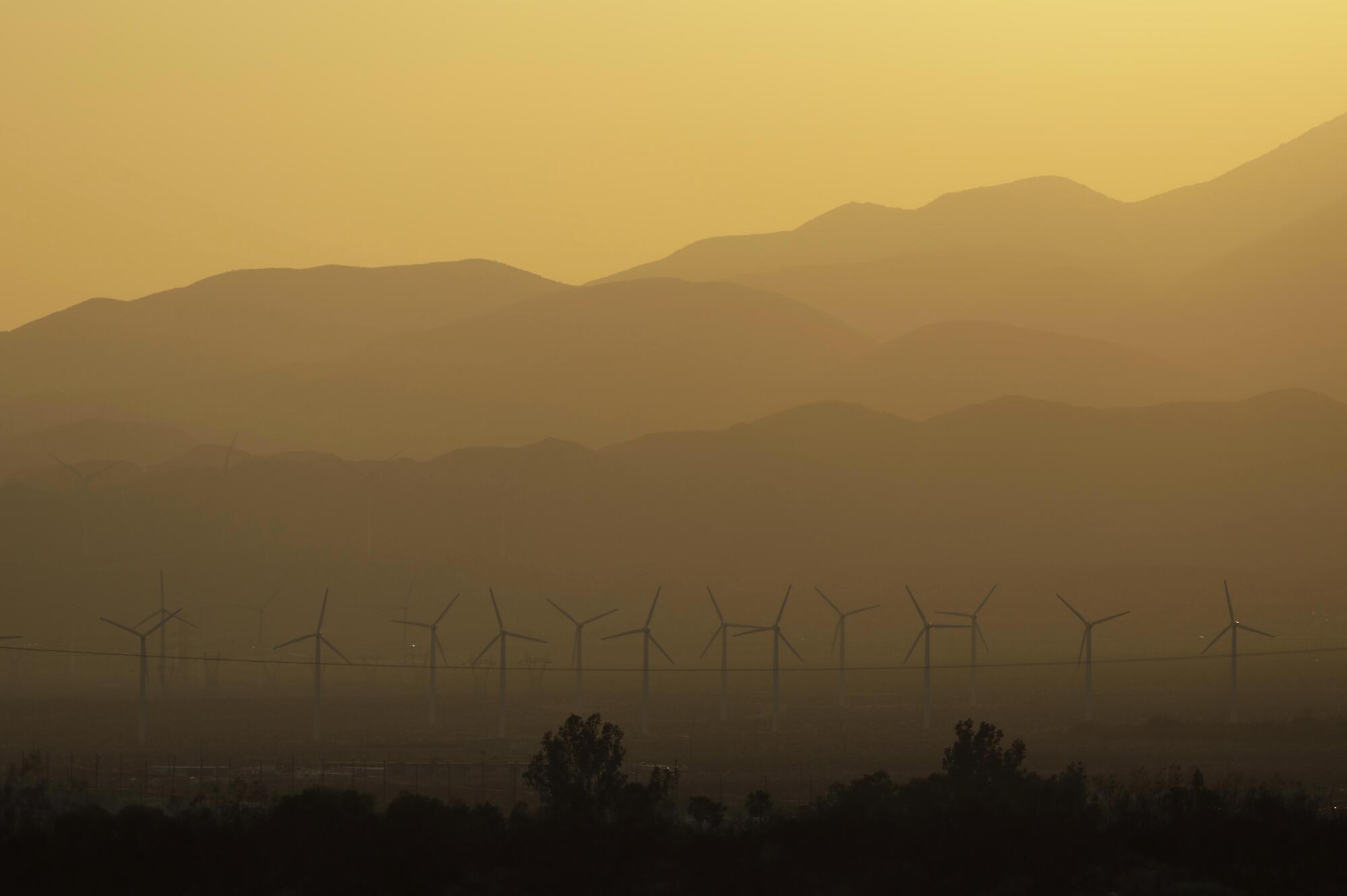 The sun sets over windmills on a day when temperatures reach 110 in Desert Hot Springs in July.