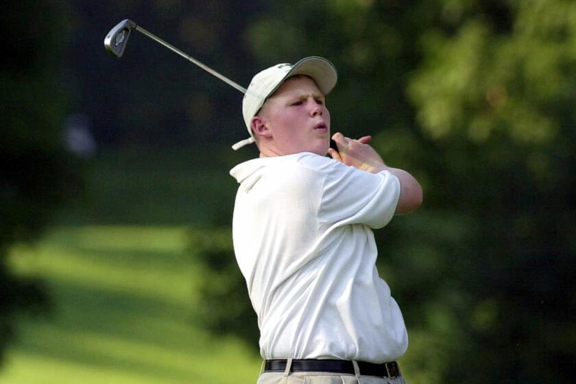 FILE - In this June 20, 2001, file photo, Andrew Giuliani, son of then-New York Mayor Rudolph Giuliani, follows through as he hits on the 11th hole at the Westchester Country Club during the 2001 Buick Classic West Course Pro-Am golf tournament in Harrison, N.Y. Giuliani was recruited for the golf team at Duke University but sued the university in 2008, saying he had been improperly cut from the team. Duke said the cut was based on bullying behavior, which Giuliani denied. The lawsuit was dismissed in 2010. (AP Photo/Kathy Willens, File)