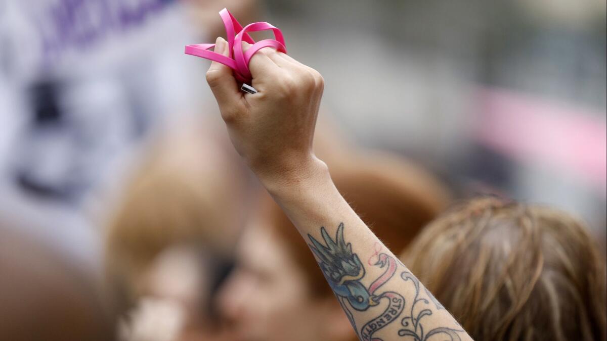 A woman shows support for sexual assault survivors at the #MeToo Survivors' March in Los Angeles on Nov. 12, 2017.