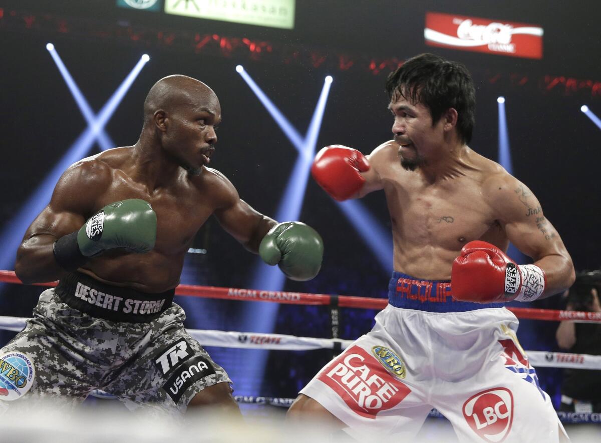 Timothy Bradley, left, and Manny Pacquiao exchange punches during their WBO welterweight title bout on April 12, 2014.