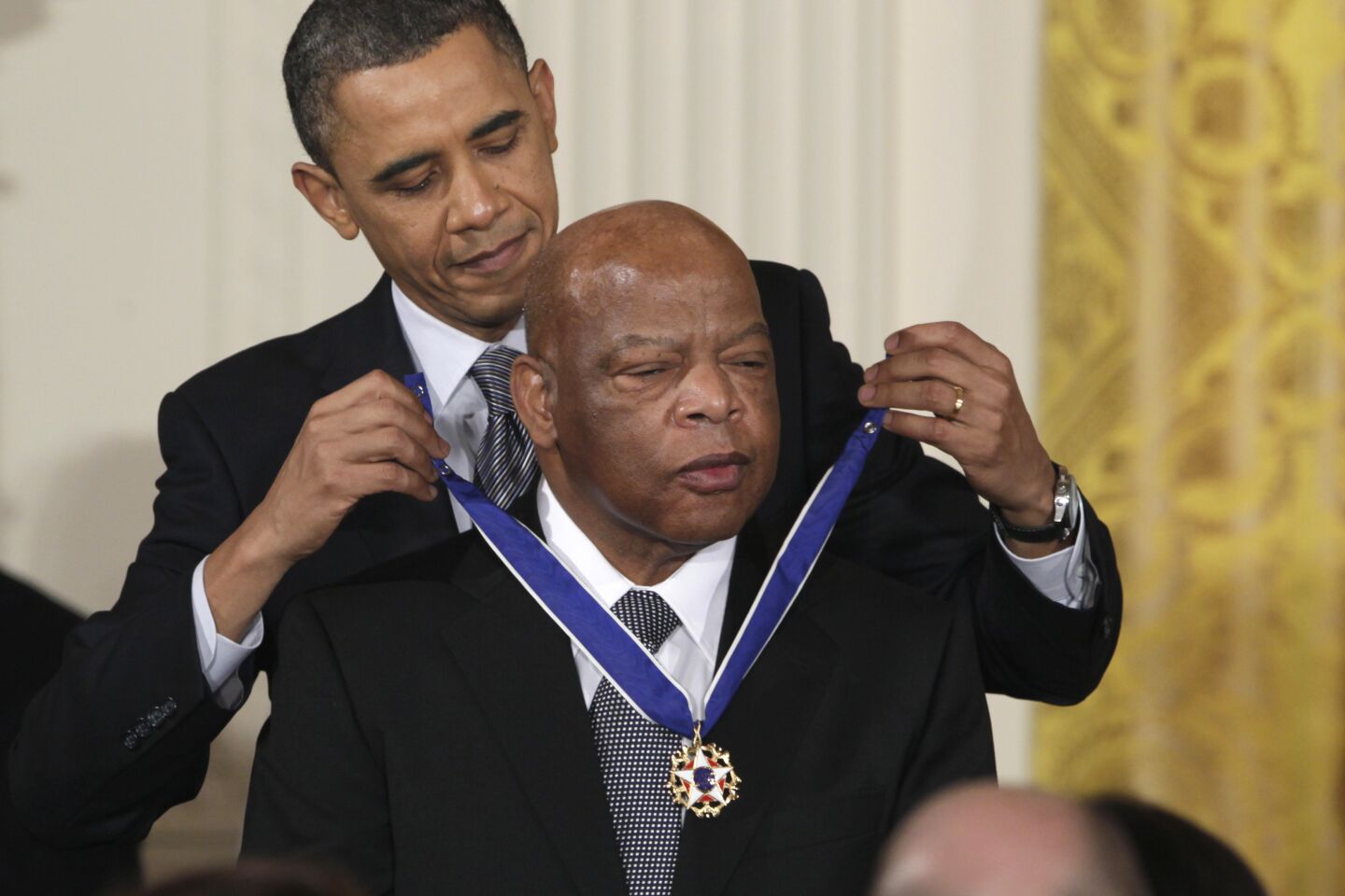 President Obama wraps the Presidential Medal of Freedom around the neck of Rep. John Lewis