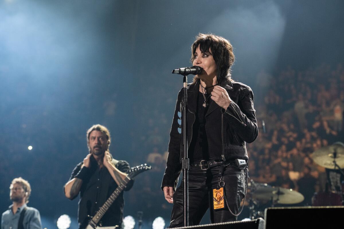 A female rock musician performs onstage