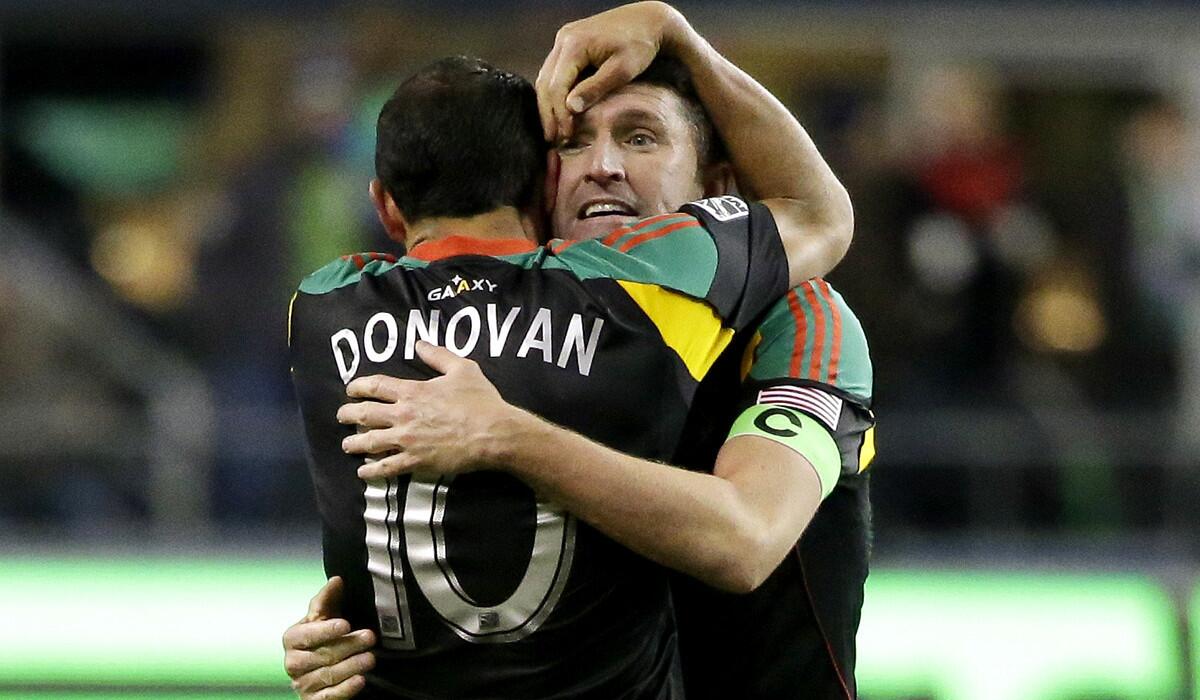 Galaxy midfielder Landon Donovan embraces captain Robbie Keane after they advanced to the MLS Cup final on Sunday by defeating the Seattle Sounders in the Western Conference finals.