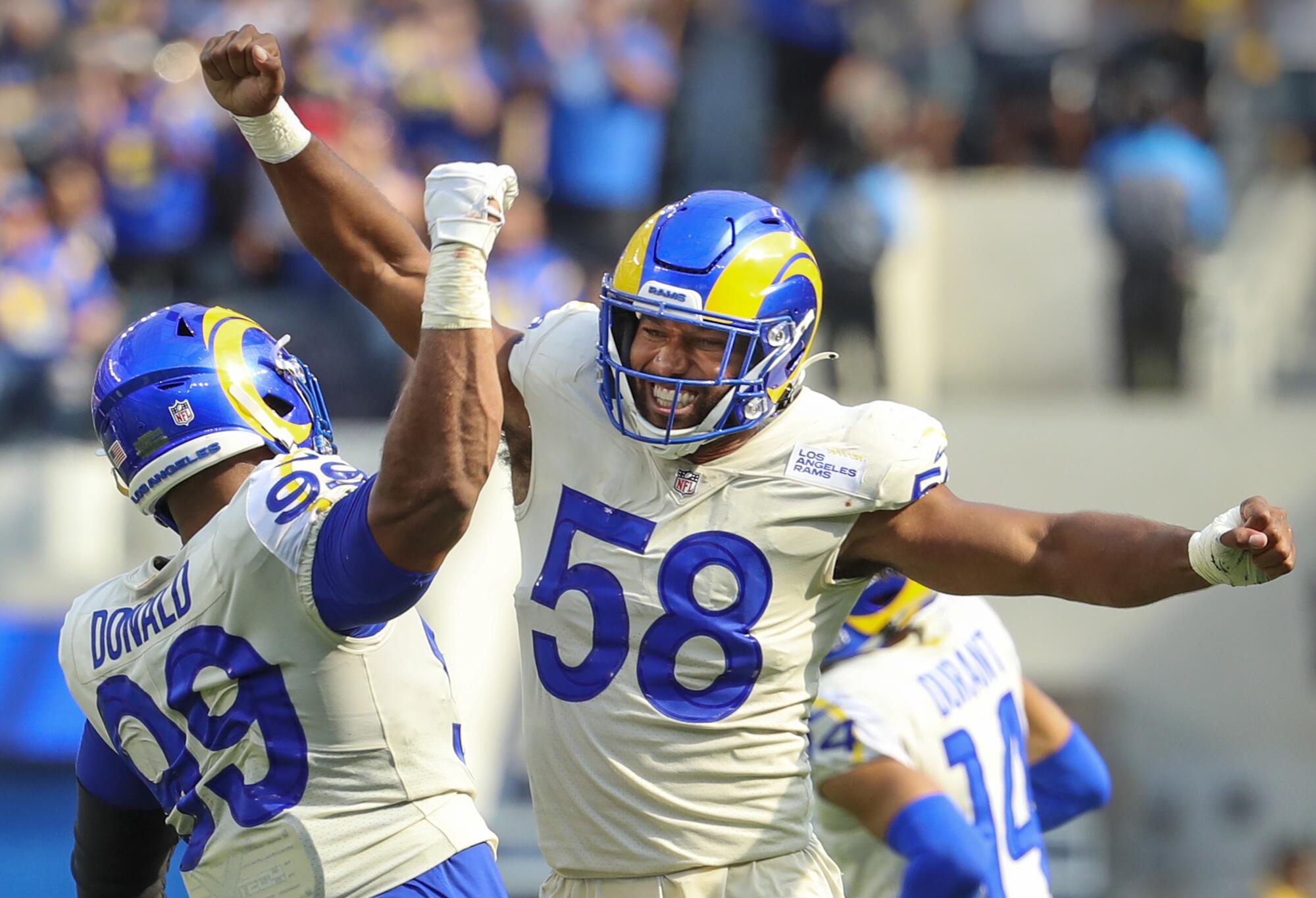 Rams defensive lineman Aaron Donald celebrates with Justin Hollins after Hollins tackled Falcons quarterback Marcus Mariota.