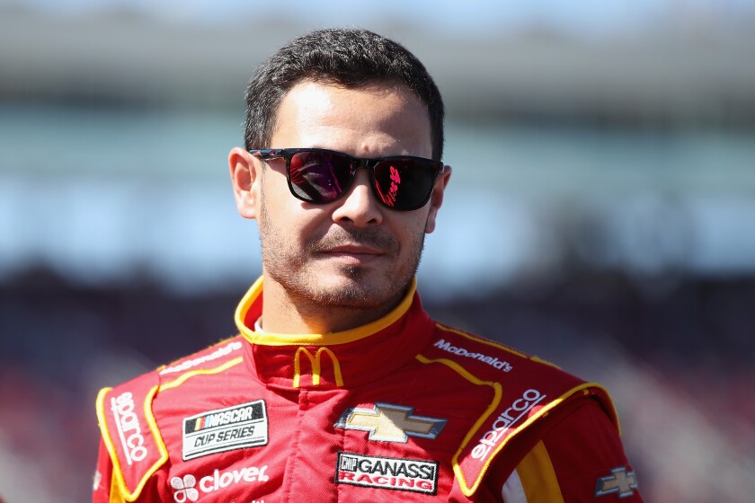Kyle Larson stands near the track at Phoenix Raceway.