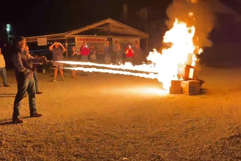 In this frame grab from video provided by Debbie McFarland, state Sen. Bill Eigel torches a pile of cardboard boxes at a “Freedom Fest” event in Defiance, Mo., Sept. 15, 2023. Eigel is a Republican candidate for Missouri governor. After video of Eigel's use of the flamethrower gained attention, Eigel said he'd burn objectionable books if that's what it took to keep them away from children. (Debbie McFarland via AP)