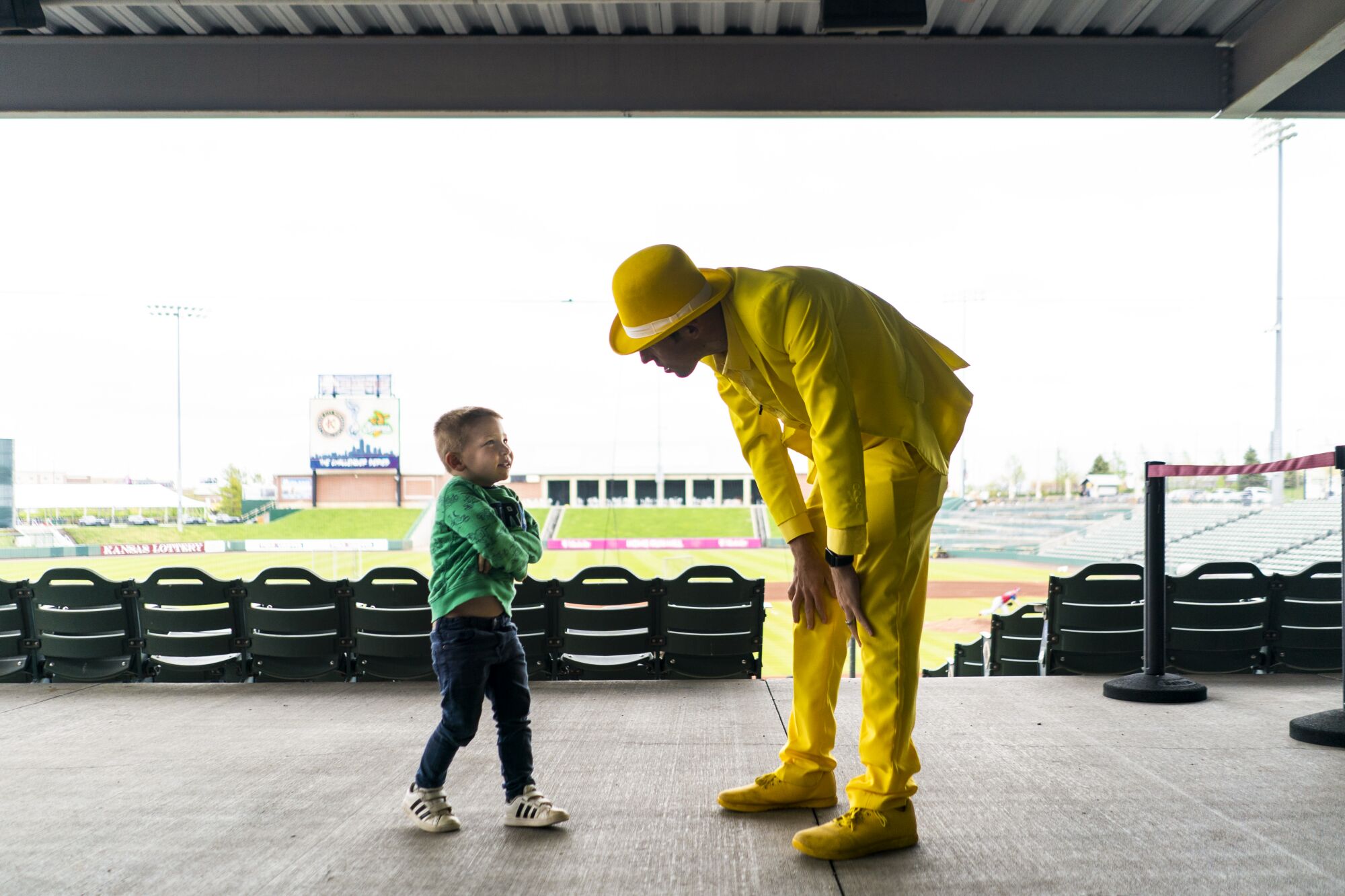 Jesse Cole, owner of the Savannah Bananas, chats with his son, Maverick, in between filming a video before a game.