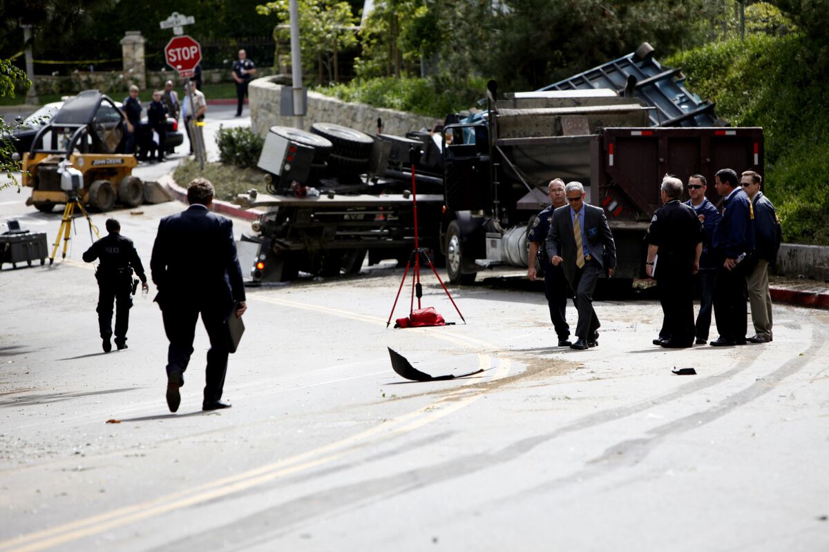 Investigators survey the aftermath of a crash that killed an LAPD officer in Beverly Hills on March 7.