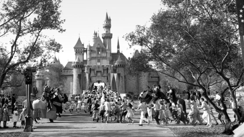 July 17, 1955: Excited children sprint across a drawbridge and into the castle that marks the entrance to Fantasyland at the opening of Disneyland during International Press Preview day. This photo was published in the July 19, 1955, edition of the Los Angeles Times.