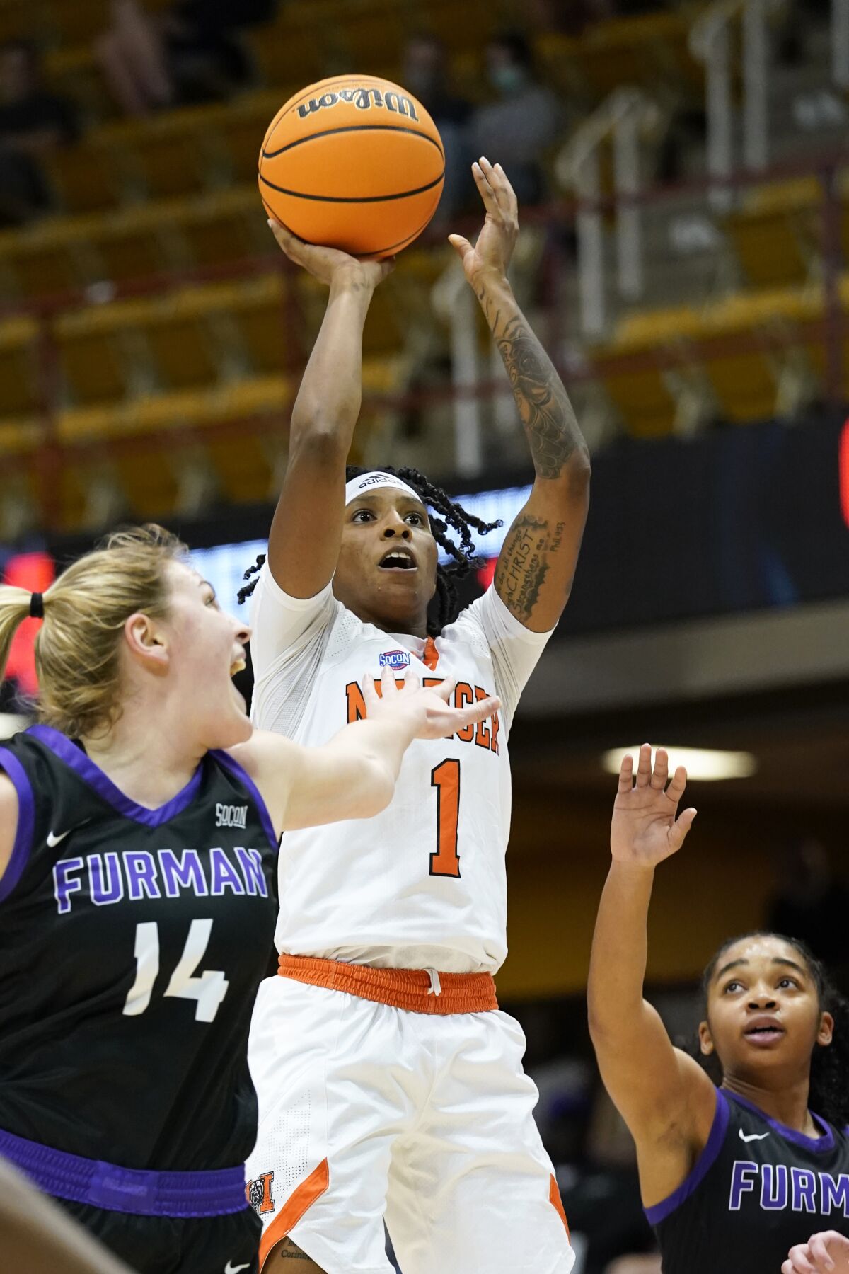 Mercer guard Amoria Neal-Tysor (1) shoots past Furman forward Grace van Rij (14) in the first half of an NCAA college basketball championship game for the Southern Conference tournament, Sunday, March 6, 2022, in Asheville, N.C. (AP Photo/Kathy Kmonicek)