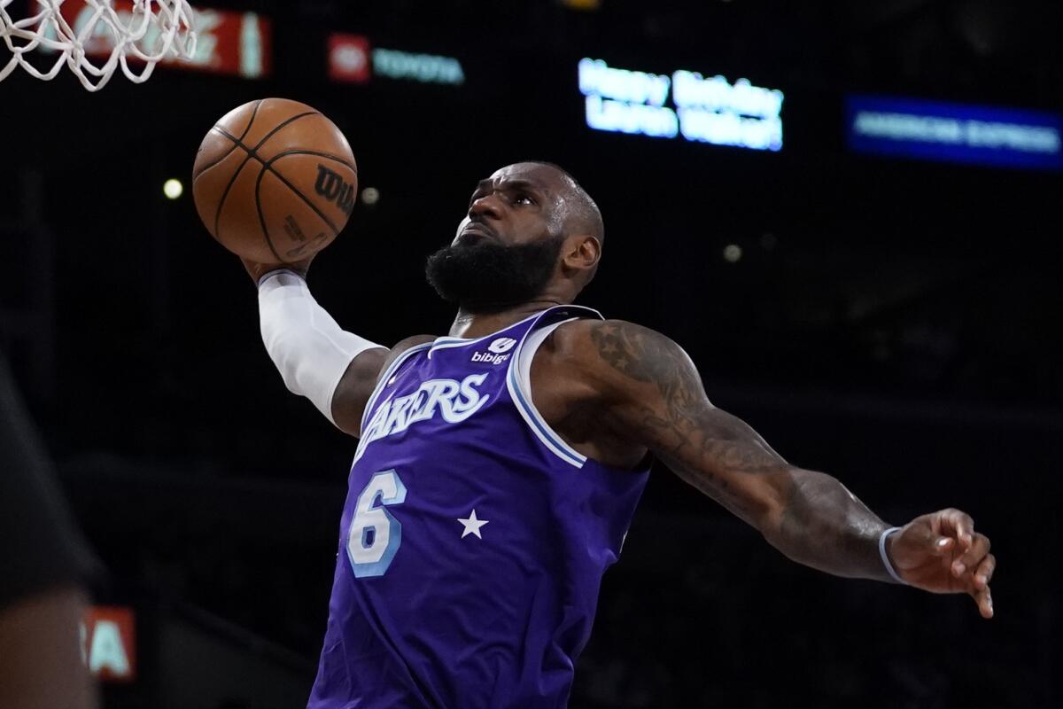 Lakers forward LeBron James dunks during a game.