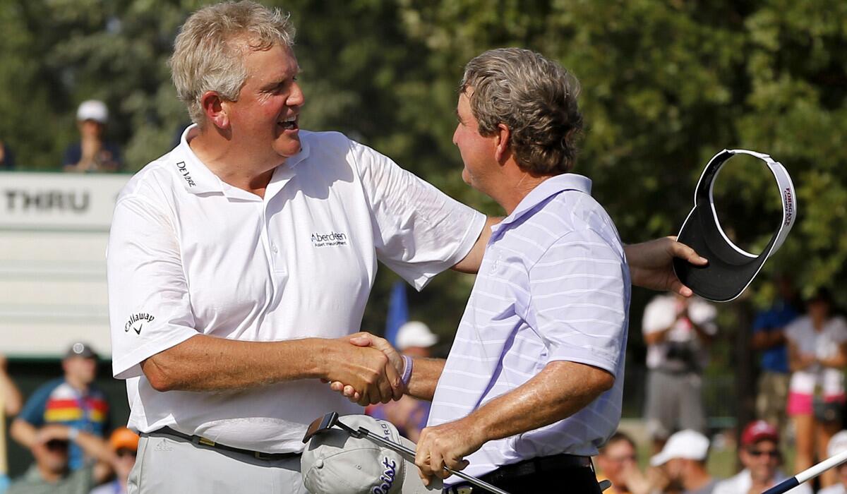 Colin Montgomerie, left, and Gene Sauers shake hands off Montgomerie won the Senior U.S. Open in a playoff on Sunday.