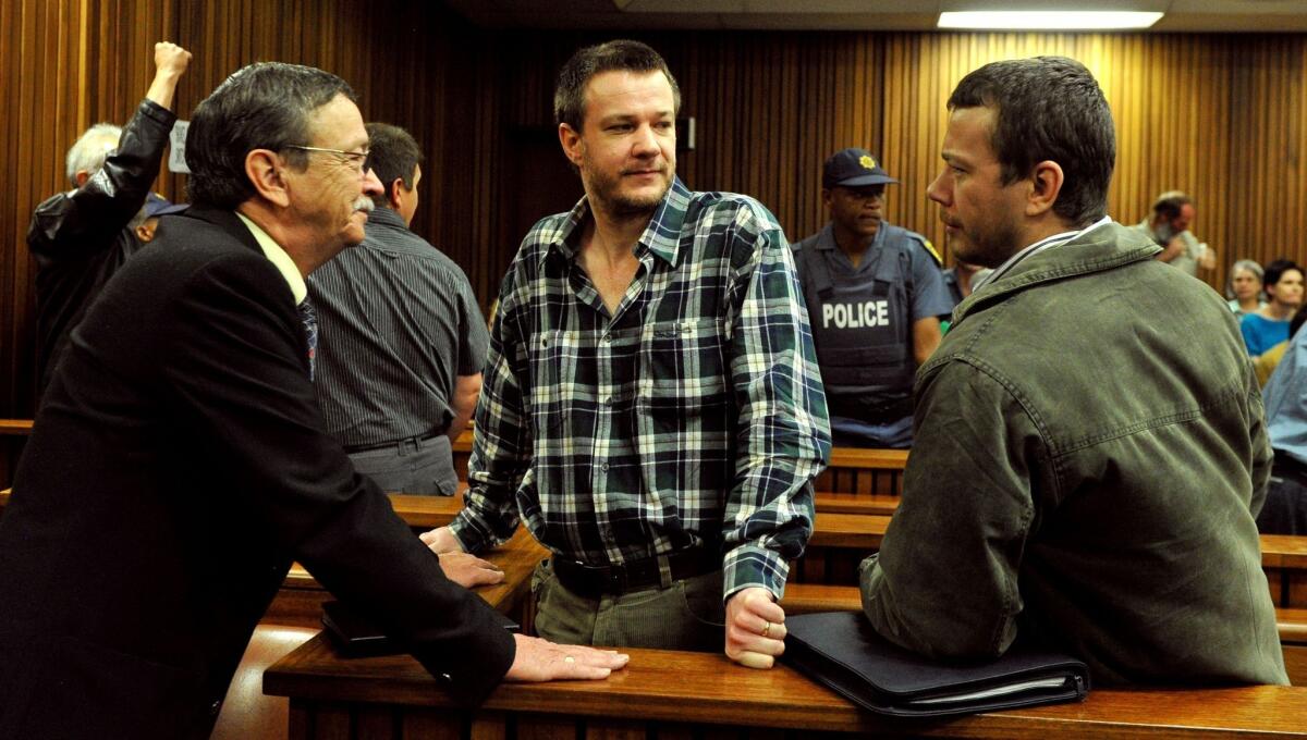 Johan and Wilhelm Pretorius, center and right, two of the South African extremists convicted of treason for a plot to kill former President Nelson Mandela and drive blacks out of the country, attend their trial at Pretoria High Court on Tuesday.