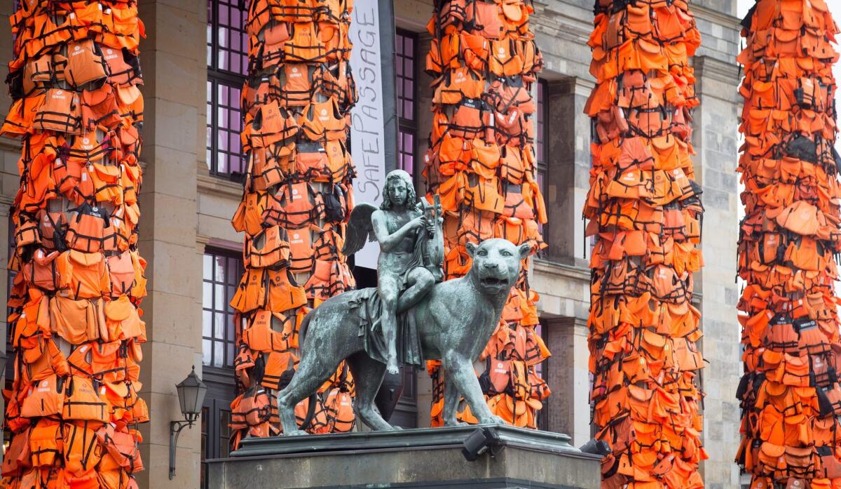 Ai Weiwei covered the pillars of Berlin's concert hall in life vests to draw attention to Europe's refugees. Aspects of the work have drawn criticism for turning the crisis into art world spectacle.