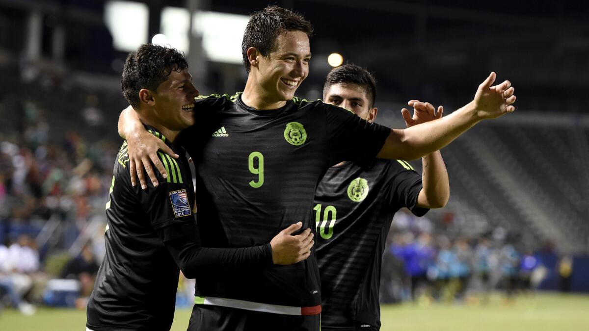 Mexico's Erick Torres (9) celebrates with teammate after scoring a goal against Costa Rica on Friday night at StubHub Center.