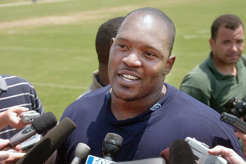 FILE - In this May 17, 2001, file photo, Tennessee Titans' Josh Evans, center, talks with reporters after practice at the Titans training facility in Nashville, Tenn. Josh Evans, a defensive tackle who started for the Tennessee Titans in the 2000 Super Bowl, has died. Evans was 48. Evans died on Thursday night, Feb. 4, 2021, in Fayetteville, Georgia, one year after he was diagnosed with kidney cancer. (AP Photo/John Russell, FIle)