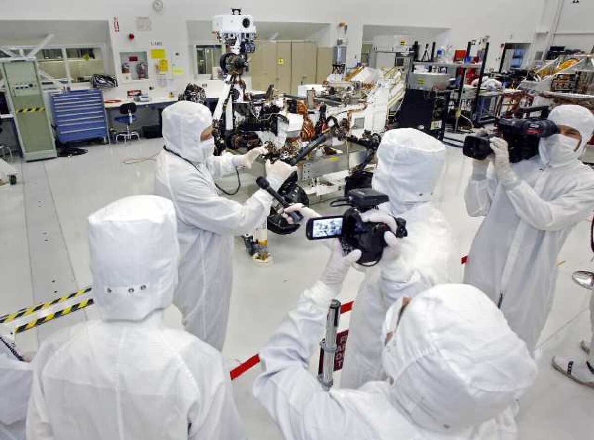 ARCHIVE PHOTO: Media members, including Bill Nye, the Science Guy, interview Peter Illsley, the rover integration lead, in the clean room at JPL on Monday, April 4, 2011 in La Canada Flintridge where the Mars rover Curiosity was assembled.