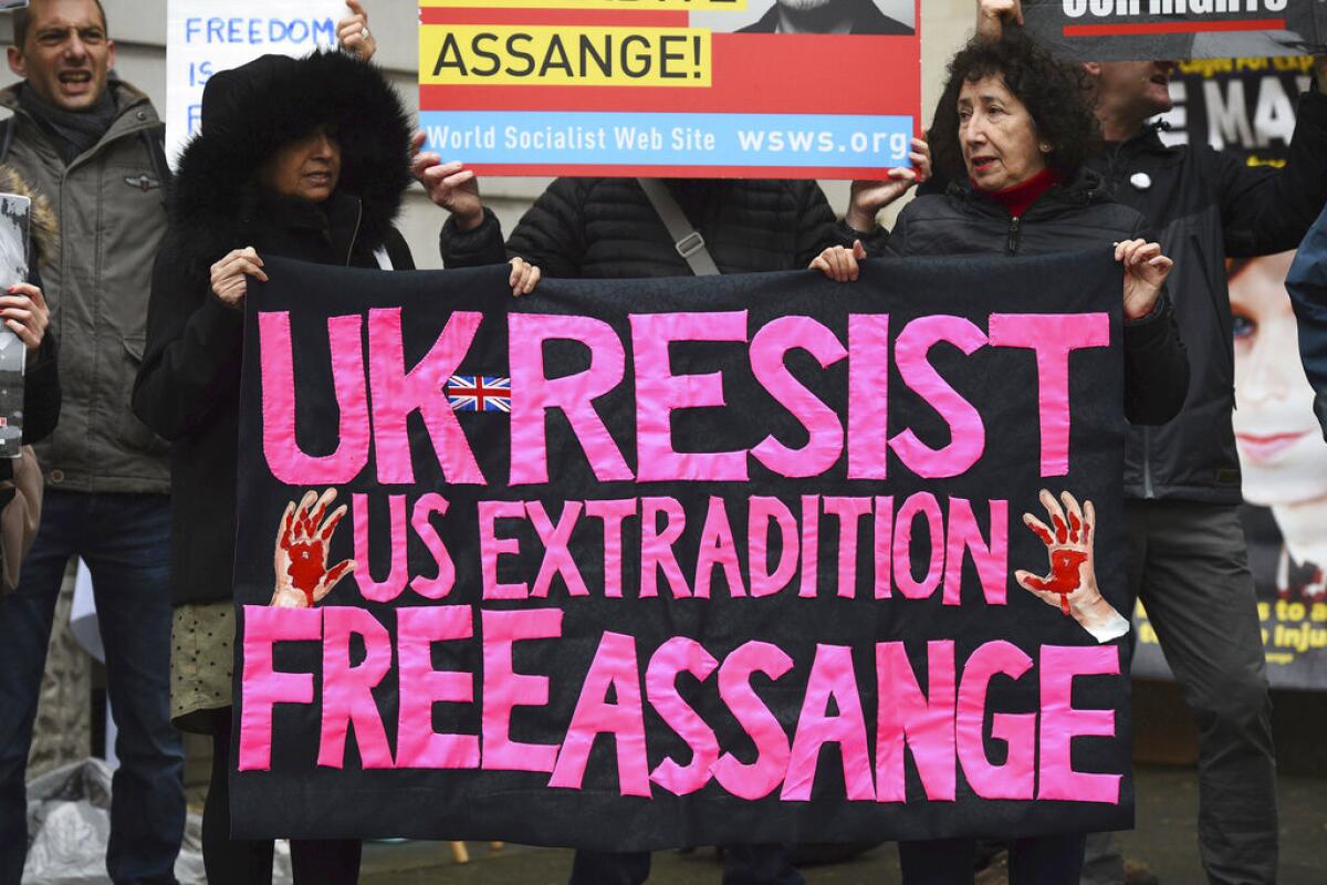 Supporters of WikiLeaks founder Julian Assange demonstrate outside Westminster Magistrates' Court in London on Monday.