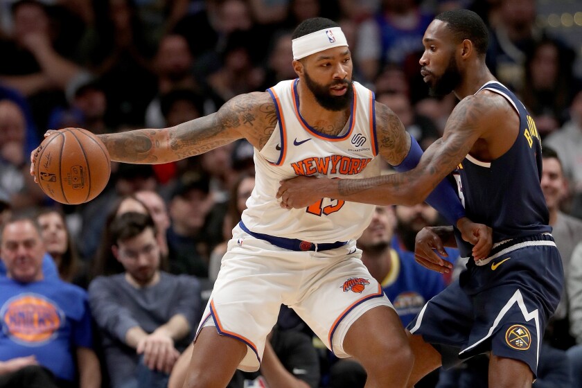 New York's Marcus Morris drives against Denver's Will Barton III on Dec. 15 at Pepsi Center.